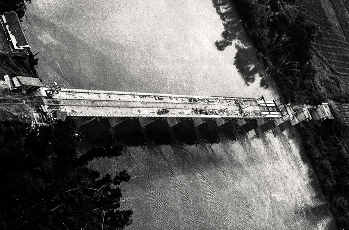 Vista aérea de obra de infraestrutura com ponte e vias de circulação.